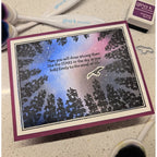 Card with star design and text, surrounded by crafting supplies on a surface.
