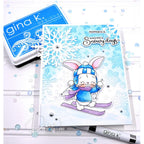 Card with a bunny skiing design, Gina K. Designs stamp and ink pad in the background.