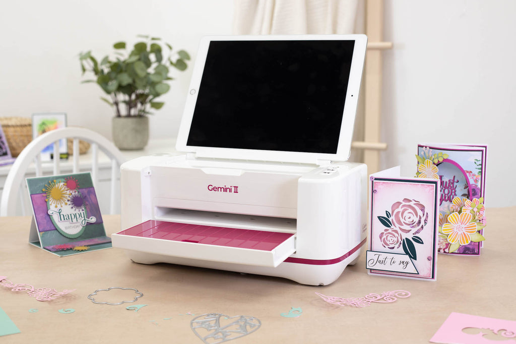 Gemini II Die Cutting And Embossing Machine gemii-m-usa with cards and ipad propped up