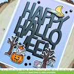 Halloween-themed card with 'Happy Halloween' text and decorative elements on a wooden background.