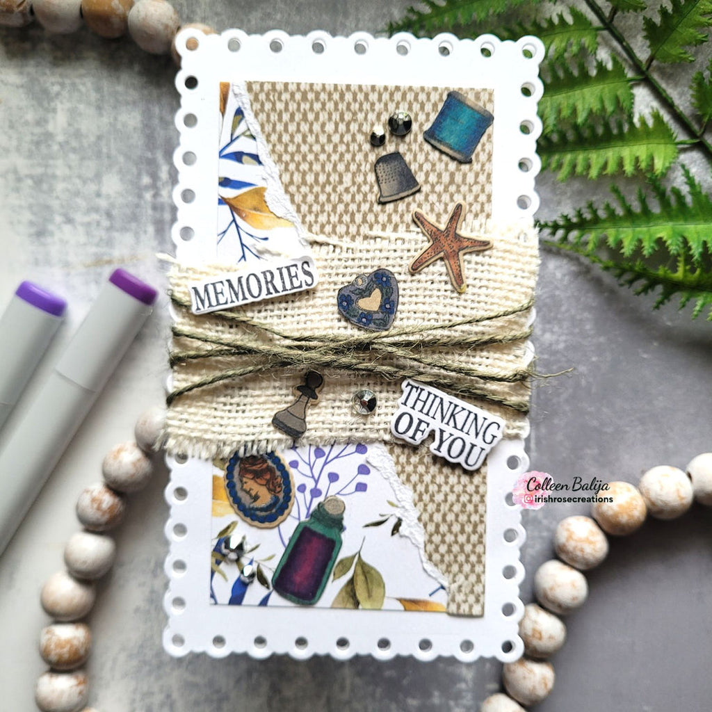 Handmade card with decorative elements and text on a textured surface with markers and beads.