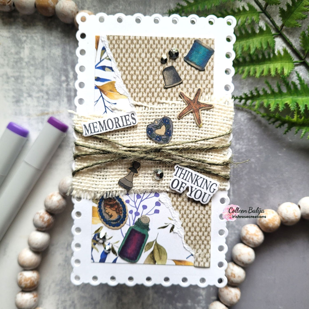 Handmade card with decorative elements and text on a textured surface with markers and beads.