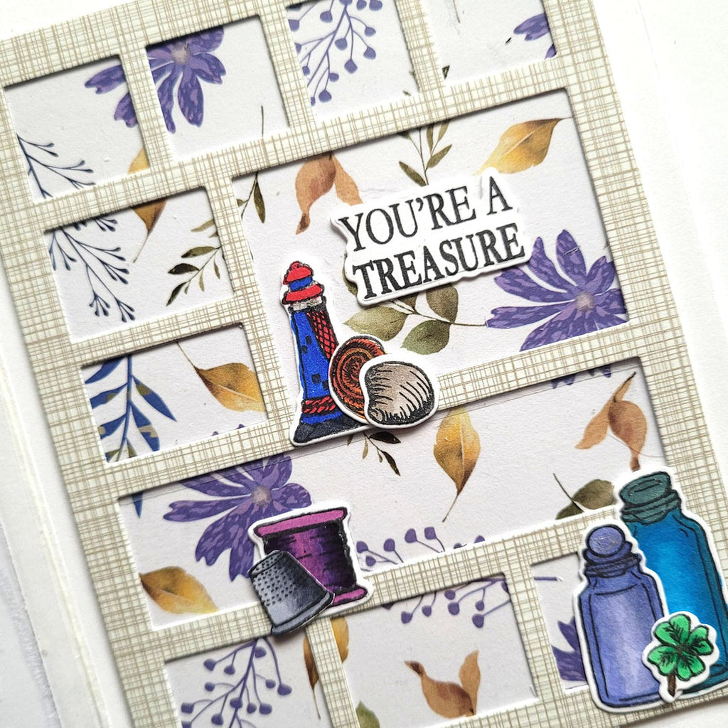 Decorative card with floral patterns, a thimble, and text on a white background