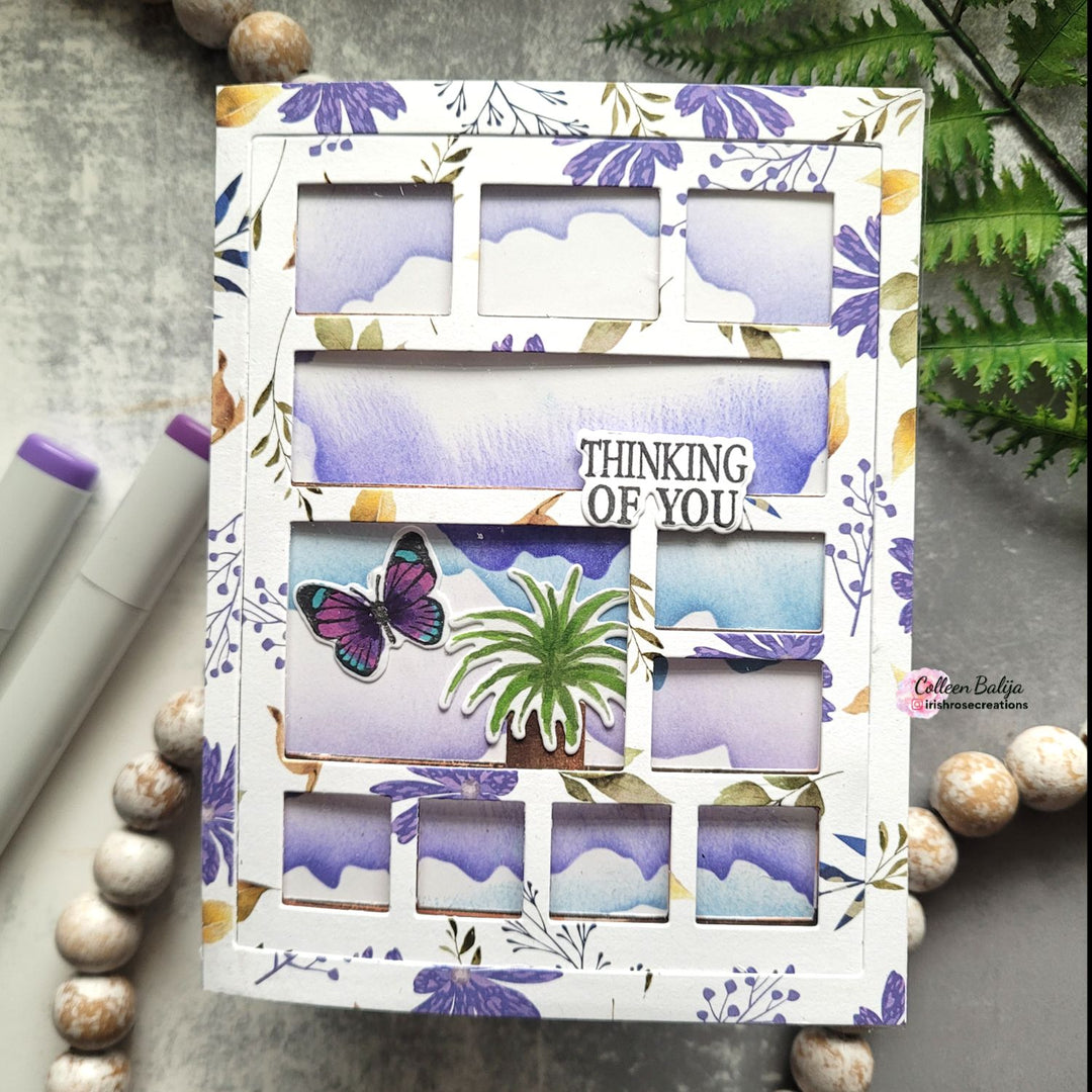 Floral and butterfly-themed card with 'Thinking of You' text on a textured surface.