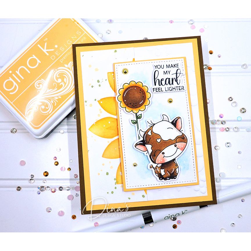 Card with a cow and sunflower design and 'gina k' branding in the background. | color-code:alt1