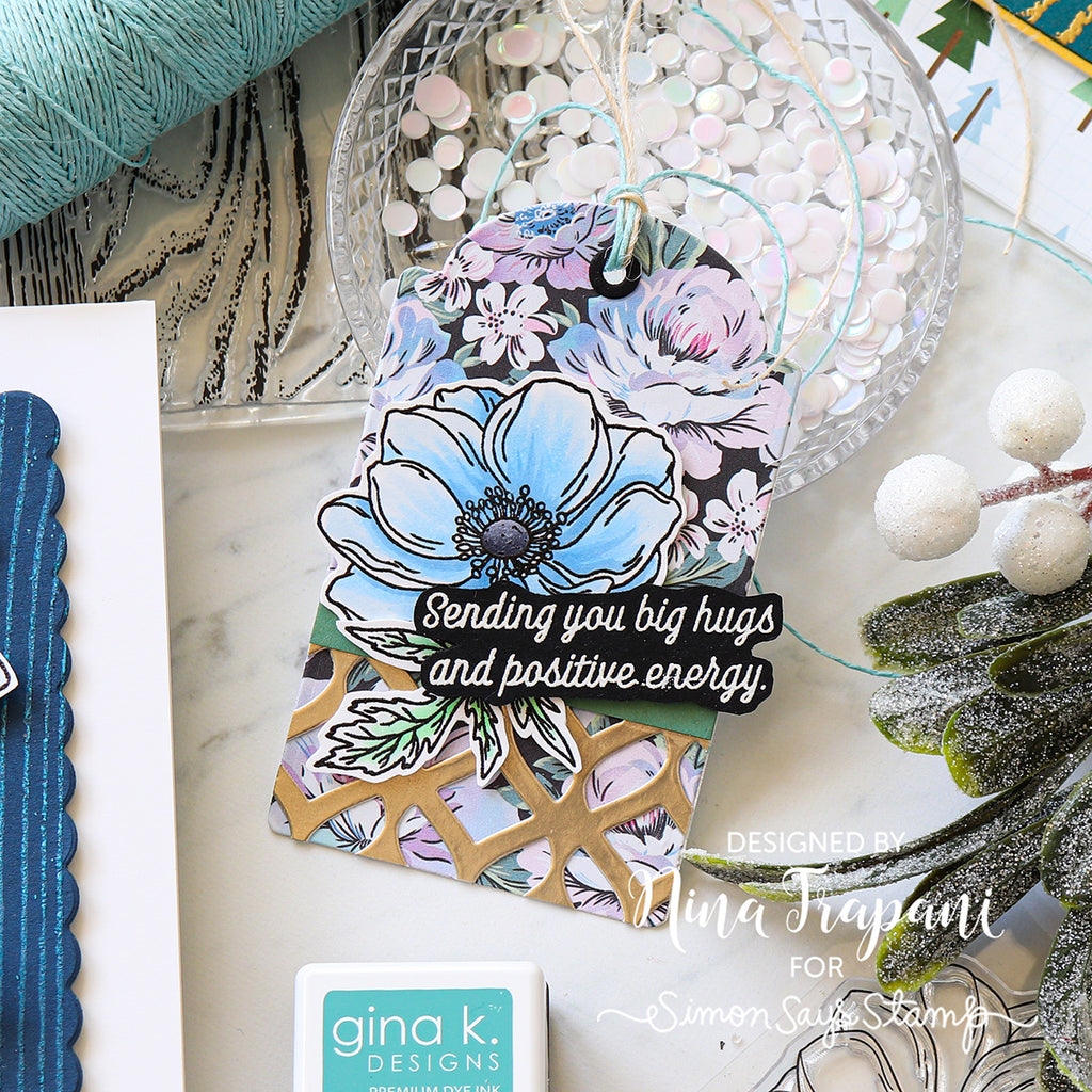 Decorative card with floral design and text on a marble surface with crafting materials.