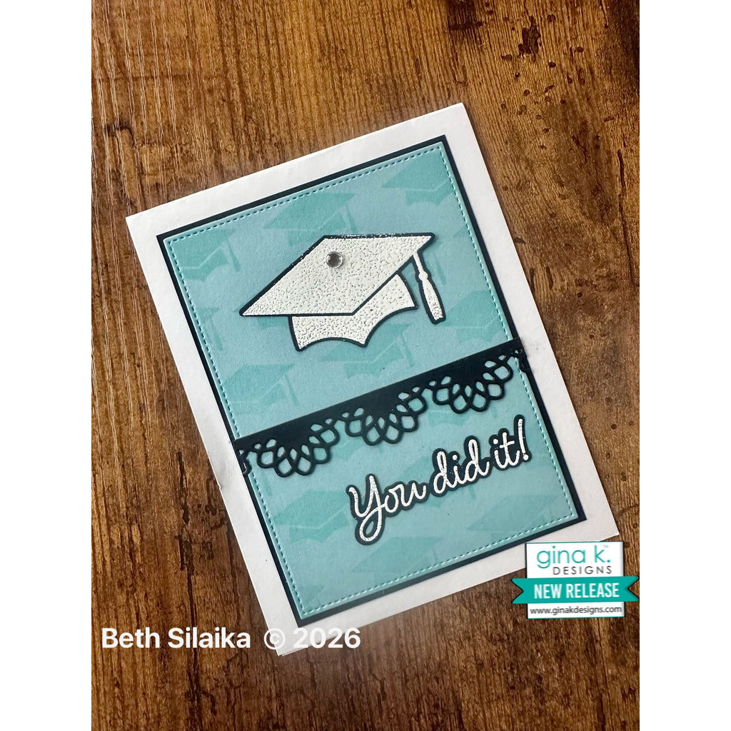 Graduation-themed card with a cap and 'You did it!' text on a wooden surface, featuring Gina K. Designs branding.