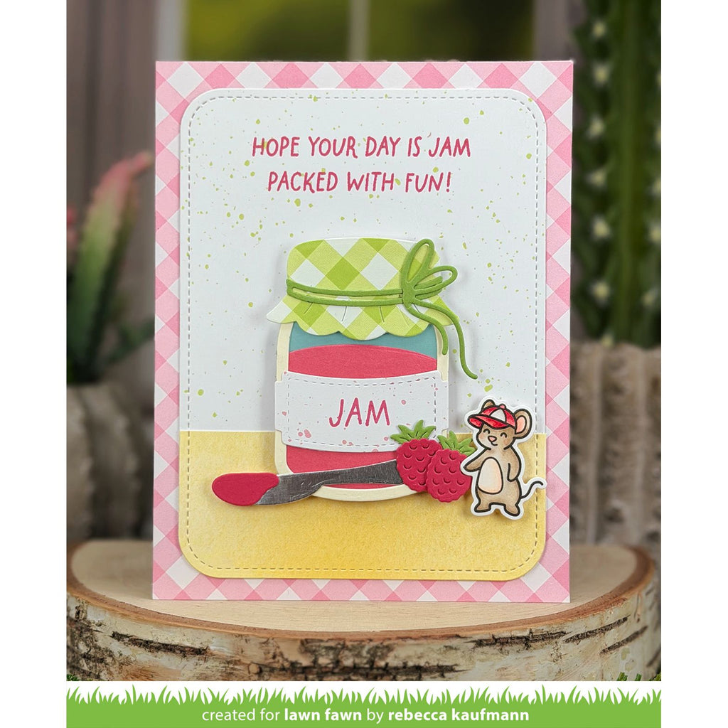 Greeting card with a jar of jam design and text 'Hope your day is jam packed with fun!' on a pink checkered background.