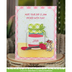 Greeting card with a jar of jam design and text 'Hope your day is jam packed with fun!' on a pink checkered background.
