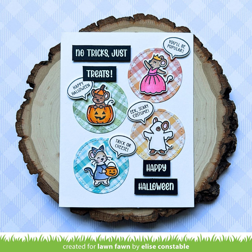 Halloween-themed card with stickers on a wooden slice against a blue background