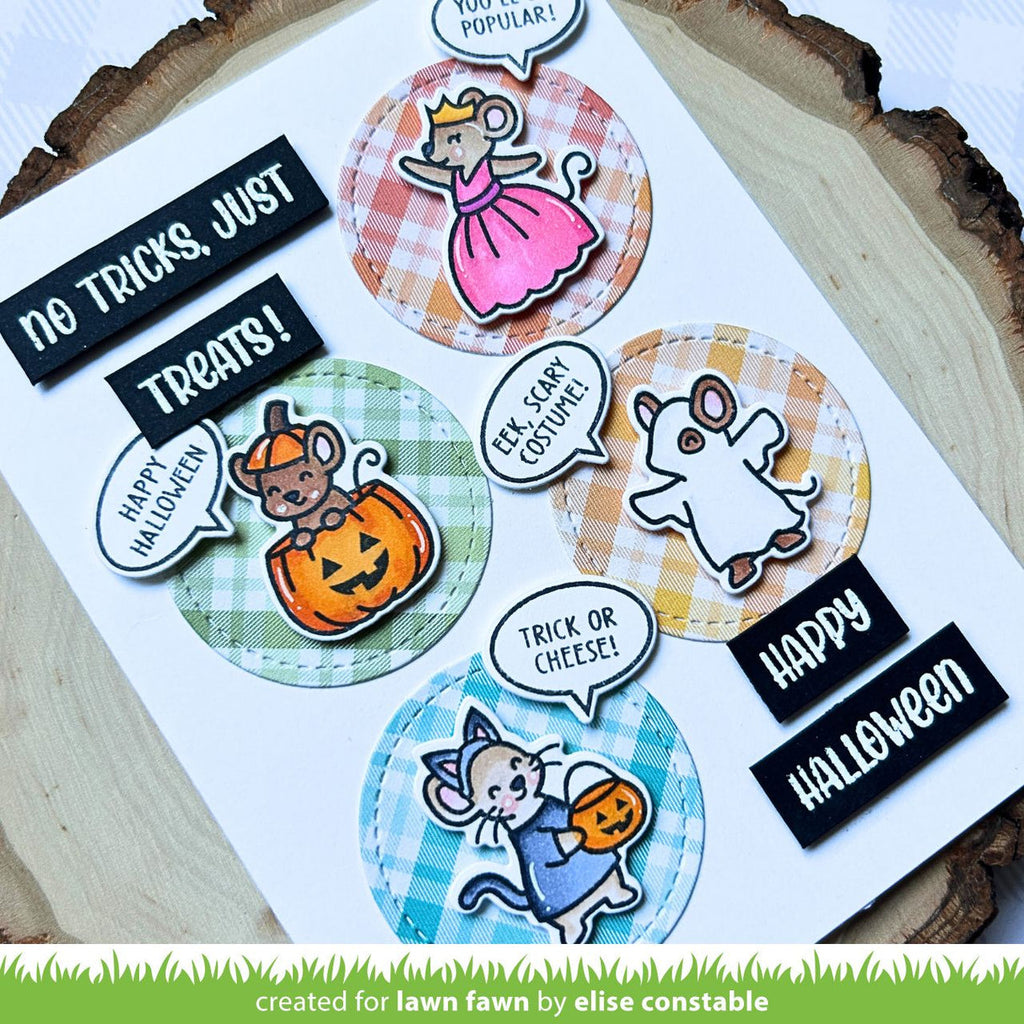 Halloween-themed stickers with cartoon characters and text on a wooden surface