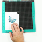 Hampton Art 10 x 10 Stamp Perfect Positioning Tool AC0746 in use pressing ink to paper with inked butterfly image