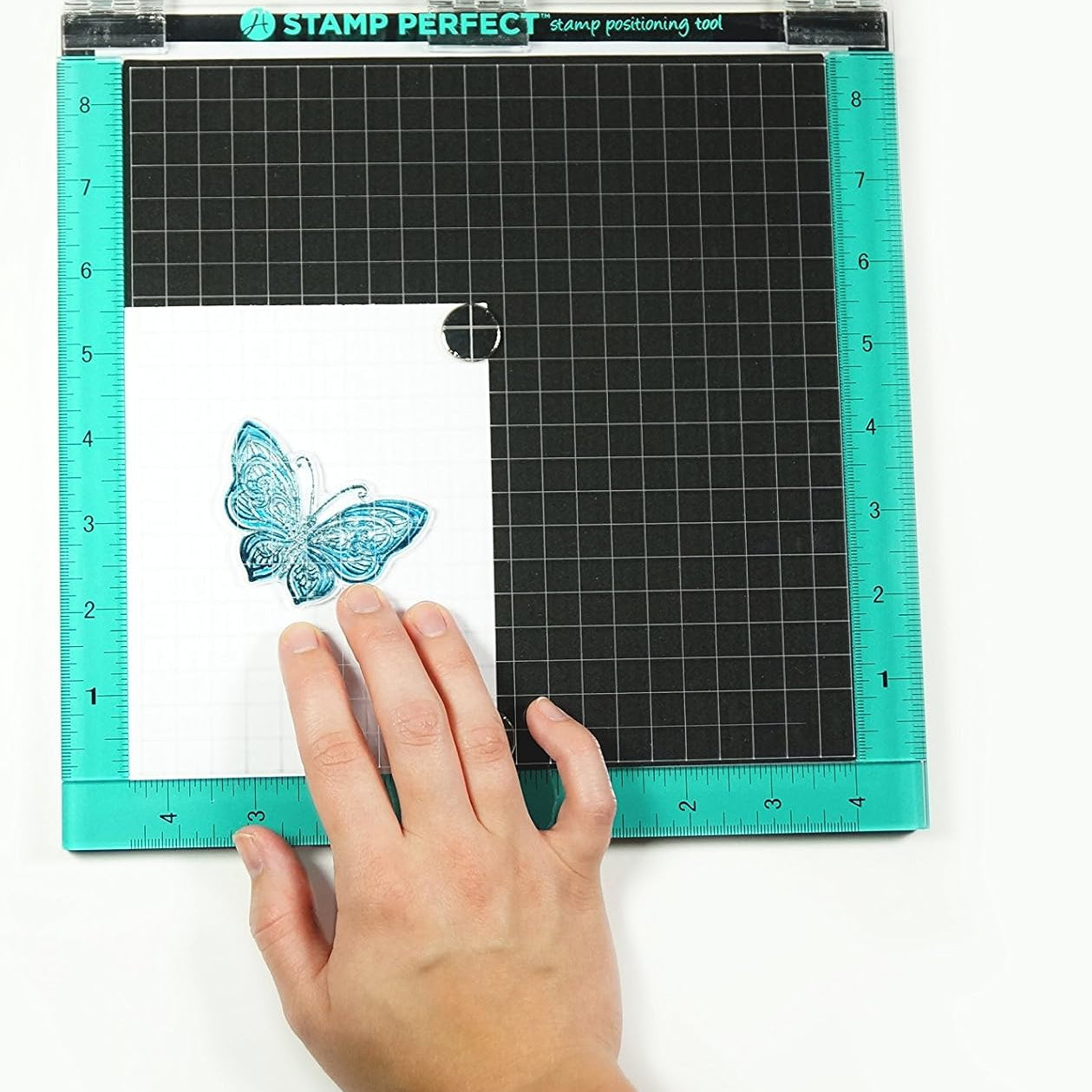 Hampton Art 10 x 10 Stamp Perfect Positioning Tool AC0746 in use pressing ink to paper with inked butterfly image