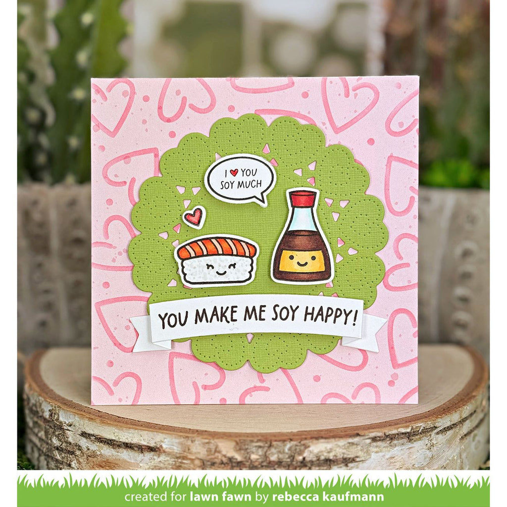 Card with cartoon sushi and soy sauce characters on a pink background with heart patterns, created by Rebecca Kaufmann for Lawn Fawn.