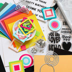 Colorful paper cutouts, stamps, and decorative items on a white surface