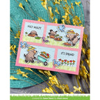 Card with moles in comic look and text on a pink border, surrounded by yellow flowers and green leaves.