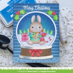 Christmas card with a rabbit in a snow globe on a decorative surface