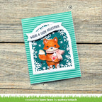 Card with a fox illustration and 'Warm & Cozy Greetings' text on a wooden surface