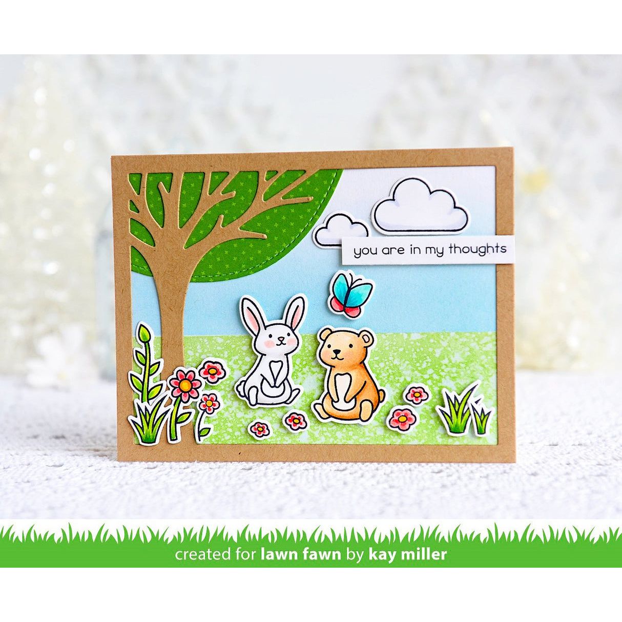 Card with bear, rabbit, butterfly, tree, and cloud with 'you are in my thoughts' message on a white background.