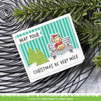 Christmas-themed card with a mouse on a bench and festive text, surrounded by greenery.