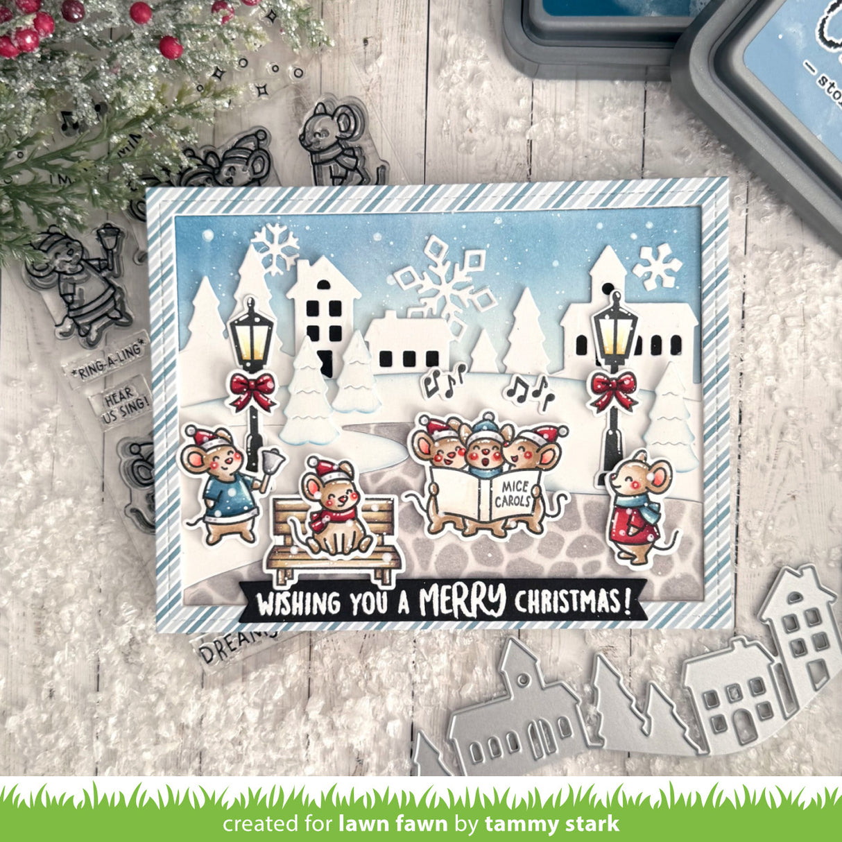 Christmas-themed card with die-cut elements on a wooden surface