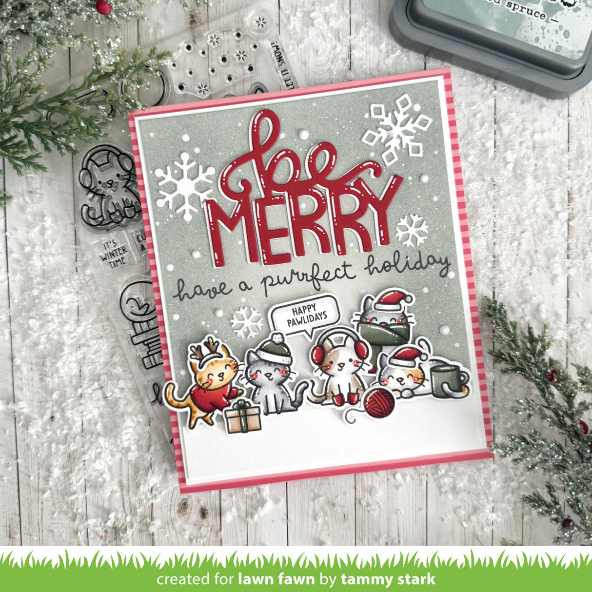 Christmas card with 'Be Merry' text and cartoon animals on a wooden surface with holiday decorations.