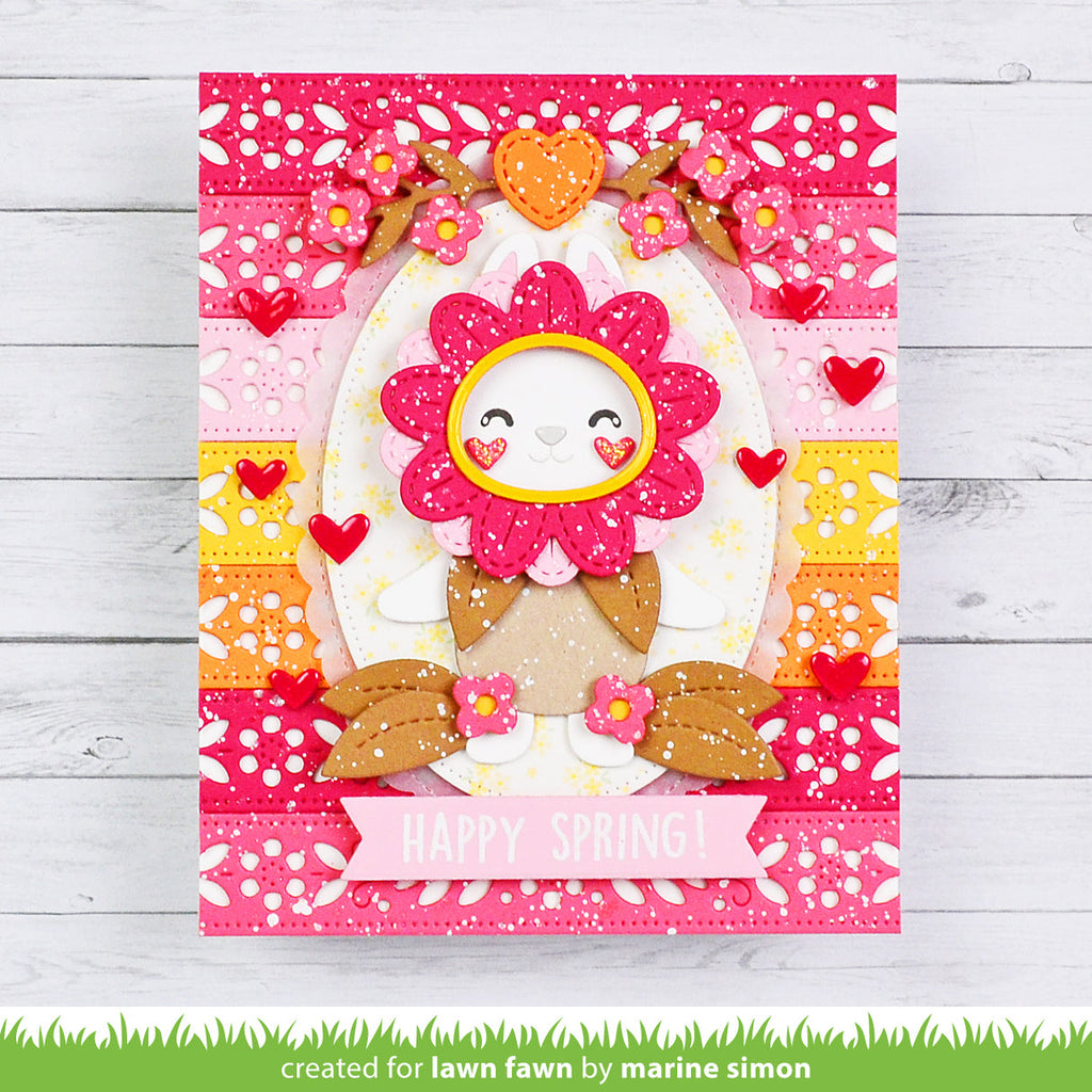Colorful card with a floral design and 'Happy Spring!' text on a wooden surface.