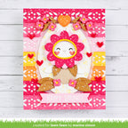 Colorful card with a floral design and 'Happy Spring!' text on a wooden surface.