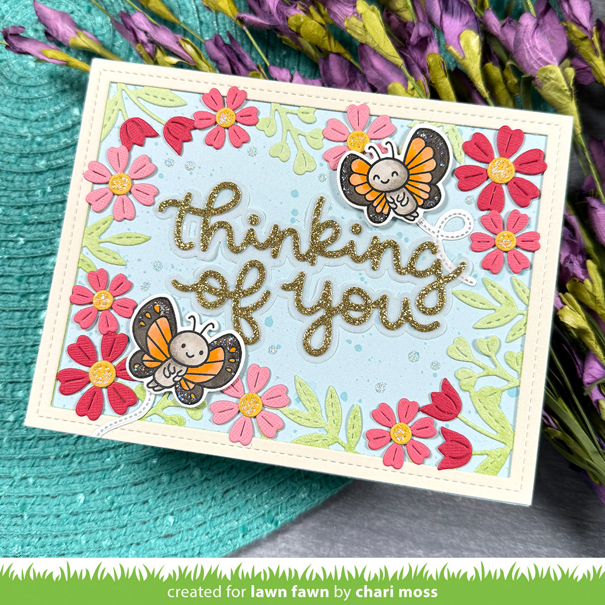 Greeting card with butterflies and flowers on a textured surface