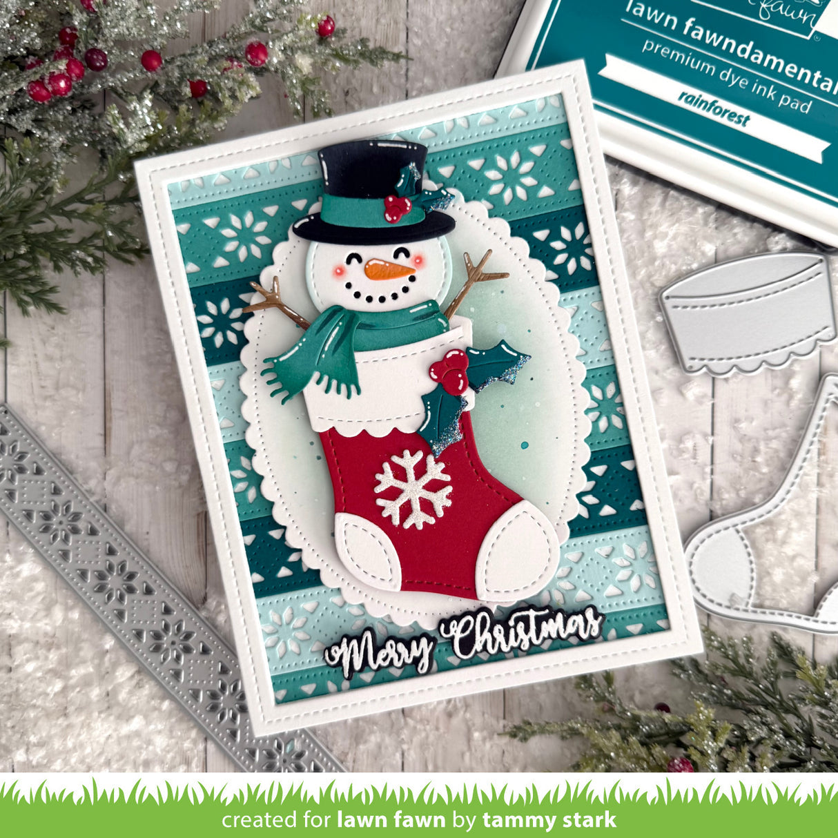 Christmas-themed card with a snowman holding a stocking and 'Merry Christmas' text, surrounded by crafting supplies.