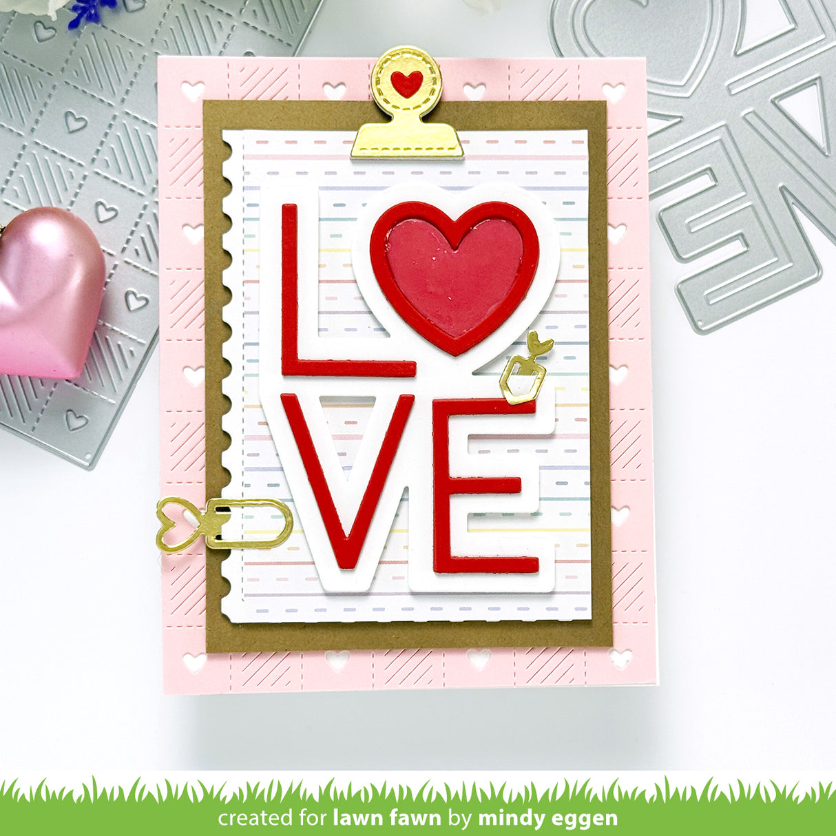 Card with 'LOVE' text and heart design, featuring a pink border and gold accents.