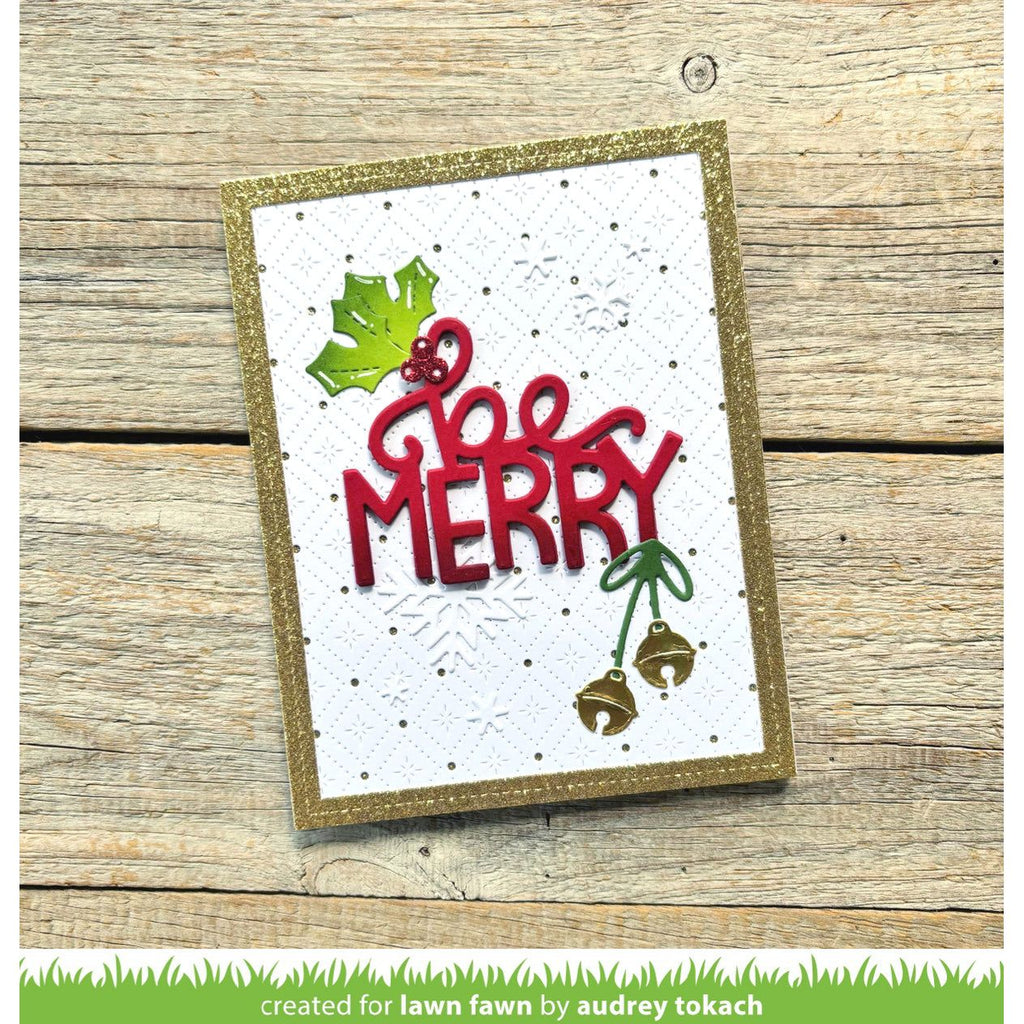 Christmas card with 'Be Merry' text on a wooden surface
