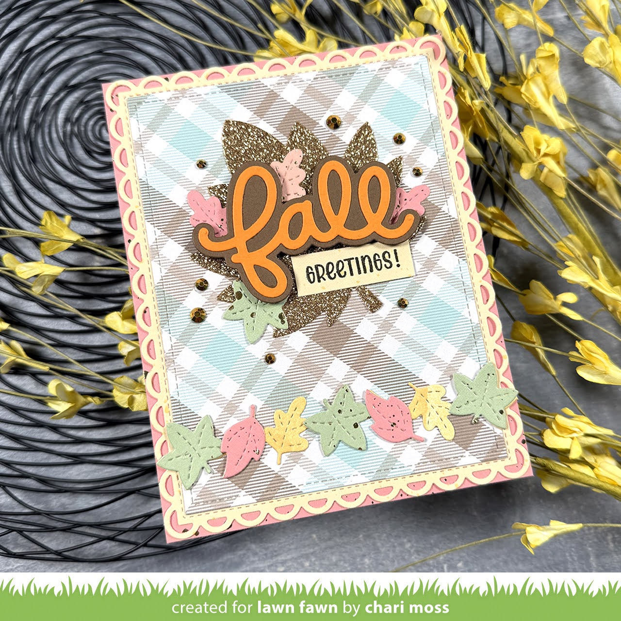 Autumn-themed card with 'fall greetings' text and decorative elements on a textured surface.