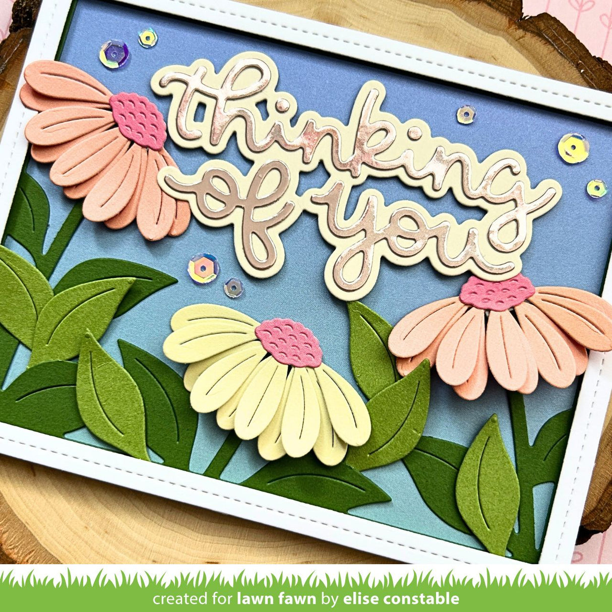 Card with 'Thinking of you' text and floral designs on a blue background