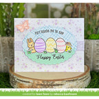 Easter card with colorful eggs and bunny on a decorative stand with plants in the background