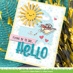 Handmade card with a sun, mouse in paper airplane and 'hello' text on a textured background