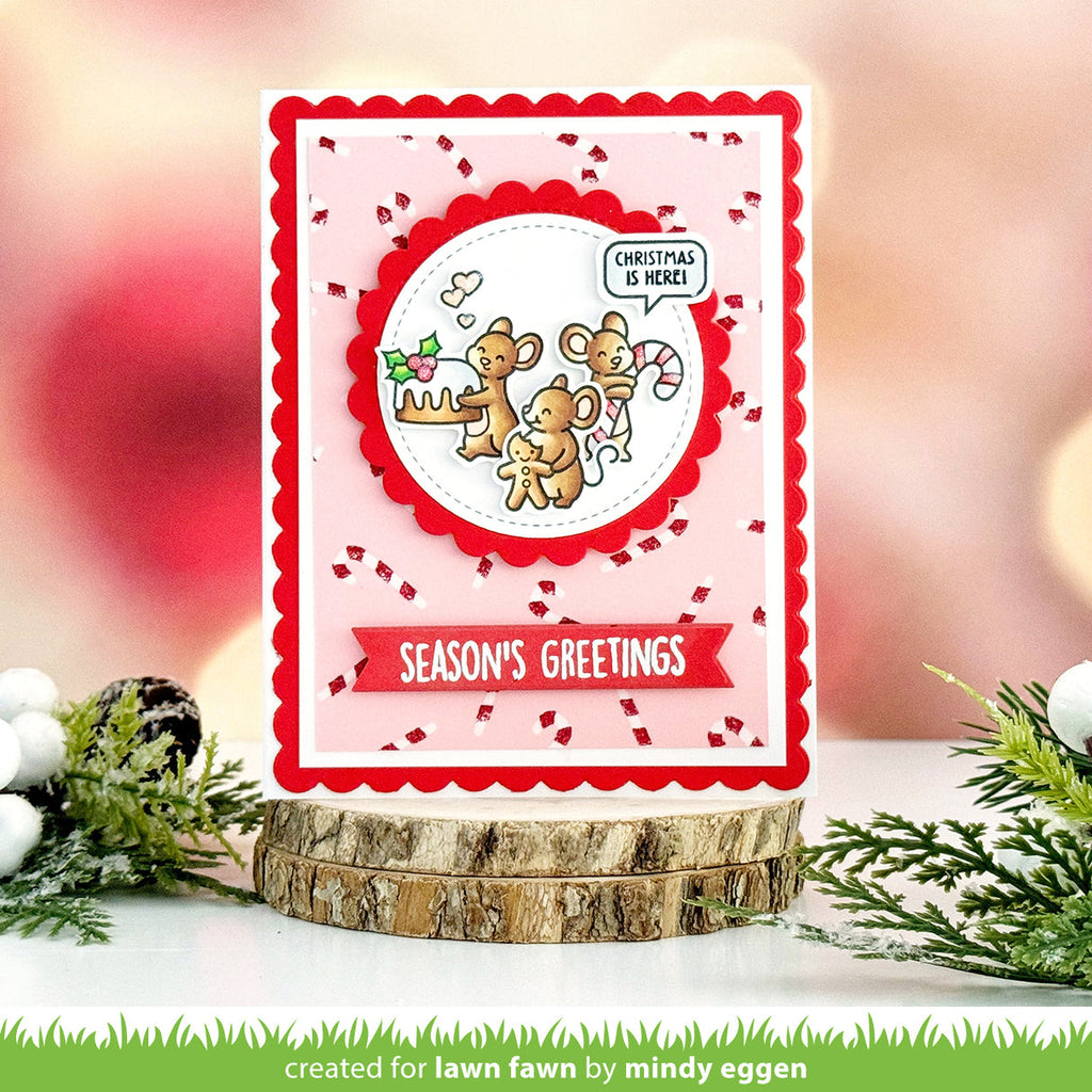 Christmas card with reindeer design on a pink background, featuring the text 'Season's Greetings'.