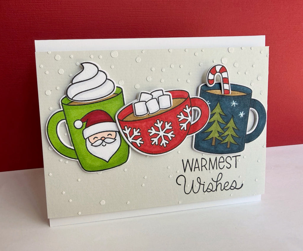 Pretty Pink Posh Warm Heart STAMPtember Exclusive card from Lisa Addessa containing the sentiment warmest wishes and three cups of cocoa in varying colors.