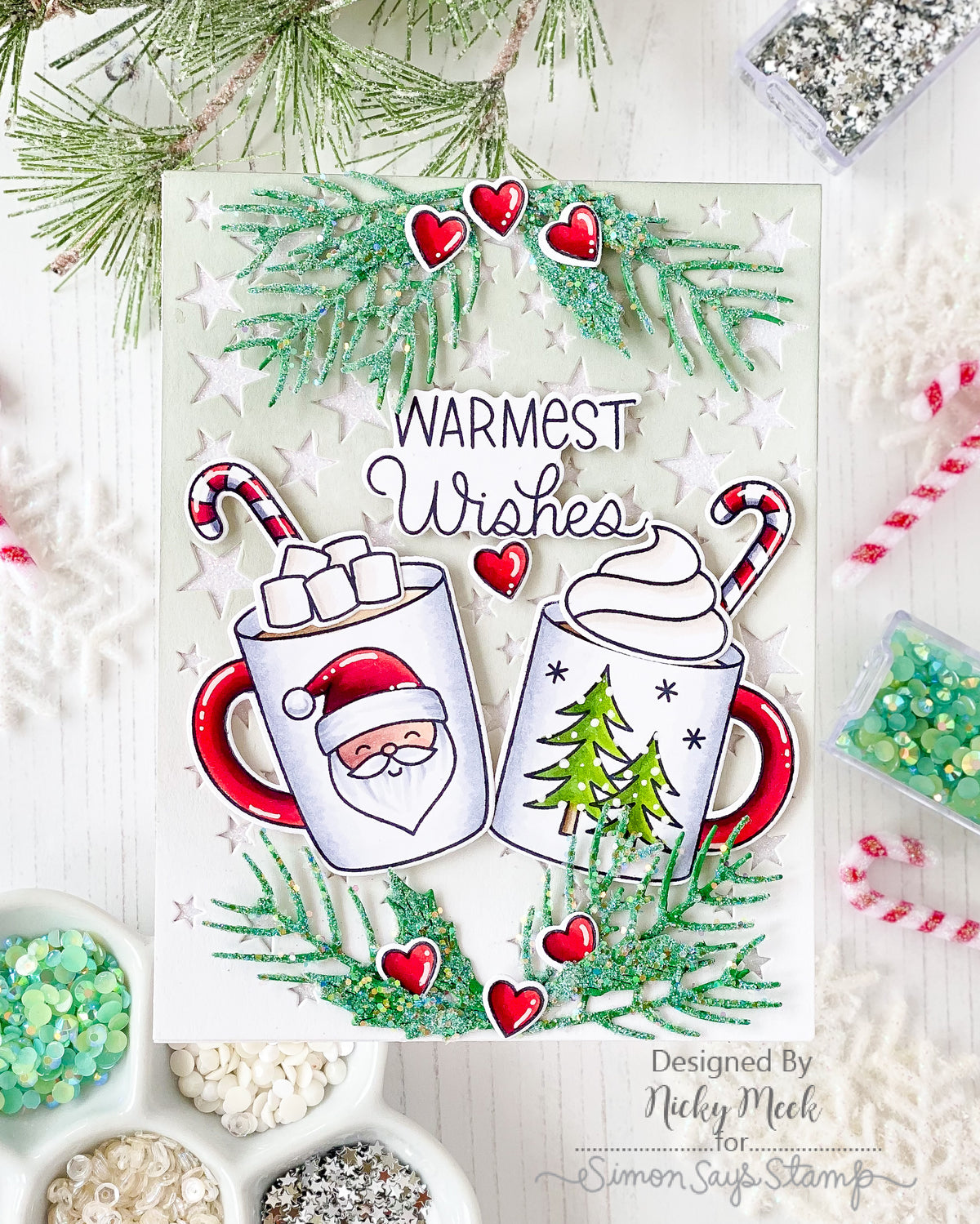 Pretty Pink Posh Warm Heart STAMPtember Exclusive Card from Nicky Meek with a die cut stars background and two cups of cocoa in the center. Warmest Wishes sentiment s above the cups of cocoa
