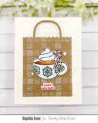 Pretty Pink Posh Warm Heart STAMPtember Exclusive Card from Sophie Ems. The card has s kraft paper bag on the front with a cup of cocoa in the foreground. The sentiment Happy holidays is below the cup