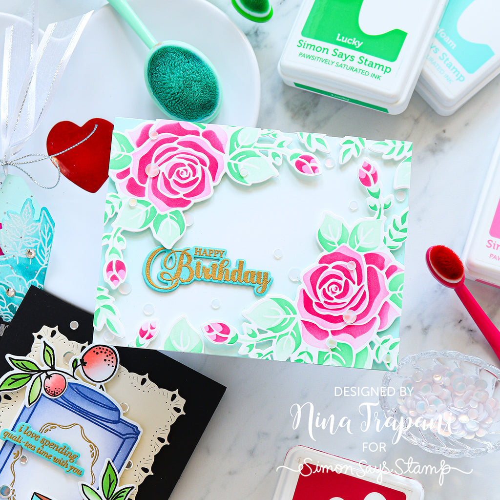 Handmade birthday card with floral design and 'Happy Birthday' text, surrounded by stamping supplies.