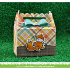 Decorative gift box with plaid pattern and fox design on a grassy background