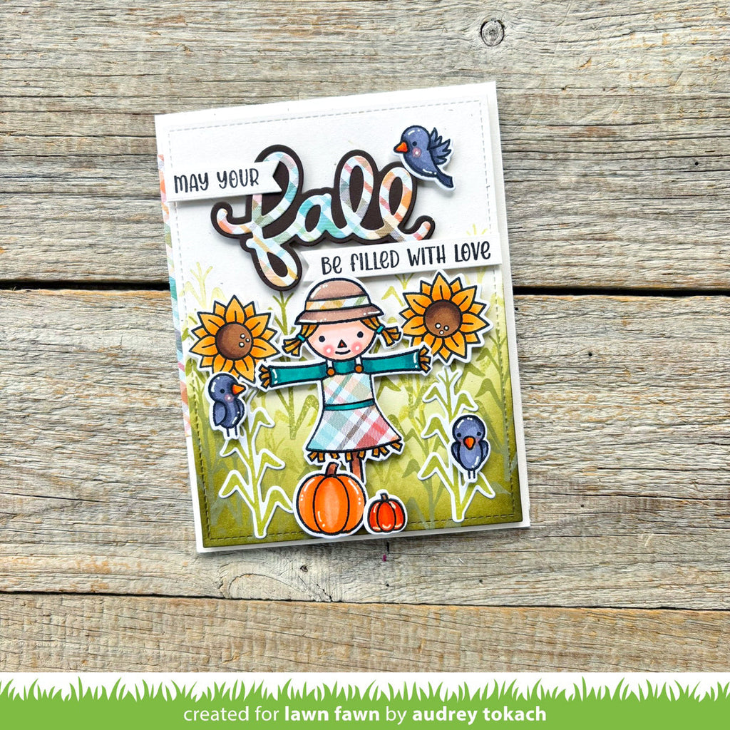 Autumn-themed card with scarecrow, pumpkins, and sunflowers on a wooden background