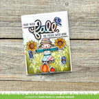 Autumn-themed card with scarecrow, pumpkins, and sunflowers on a wooden background