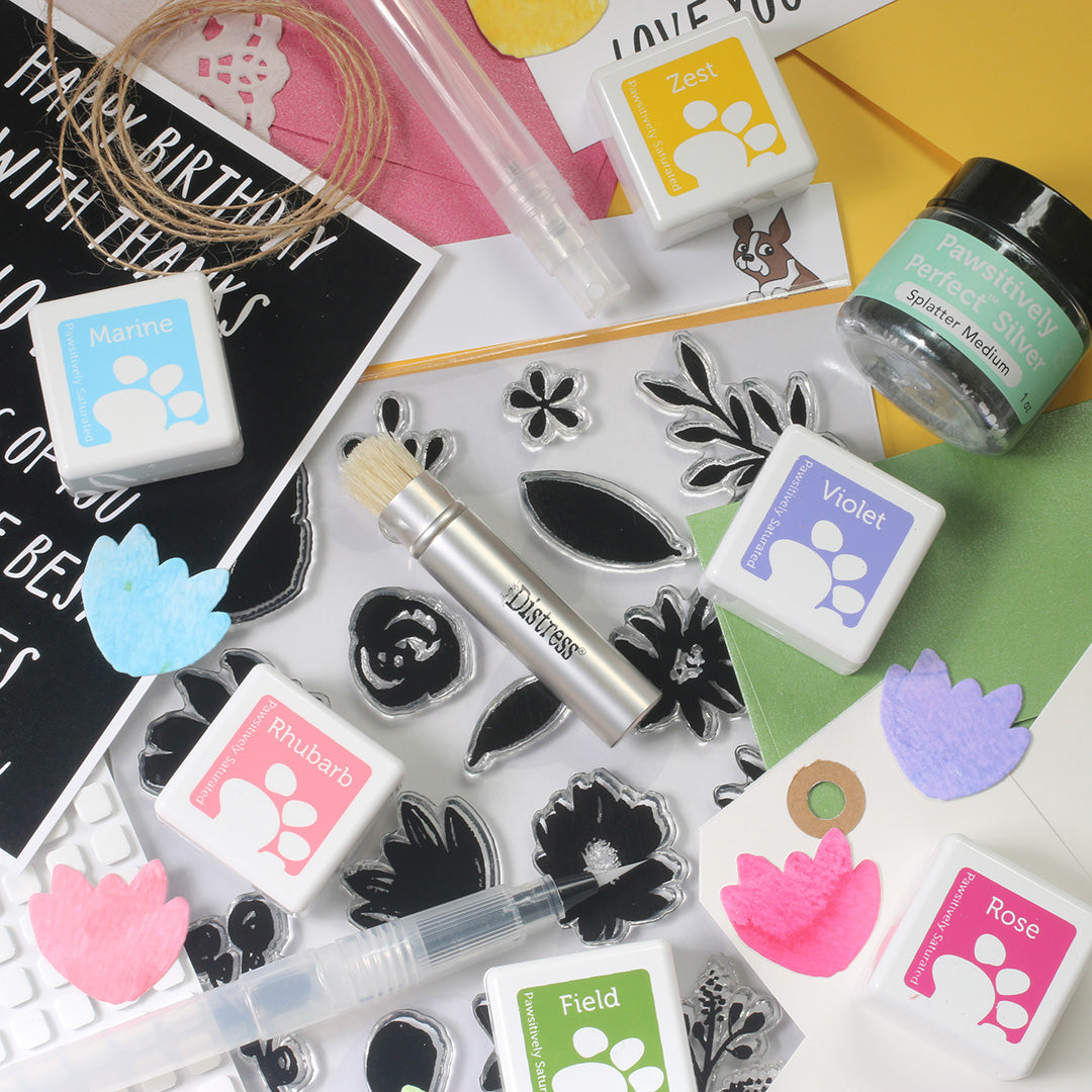 Stamping tools and ink pads on a colorful background