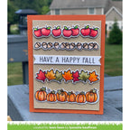 Autumn-themed card with pumpkins, leaves, and acorns on a wooden surface.