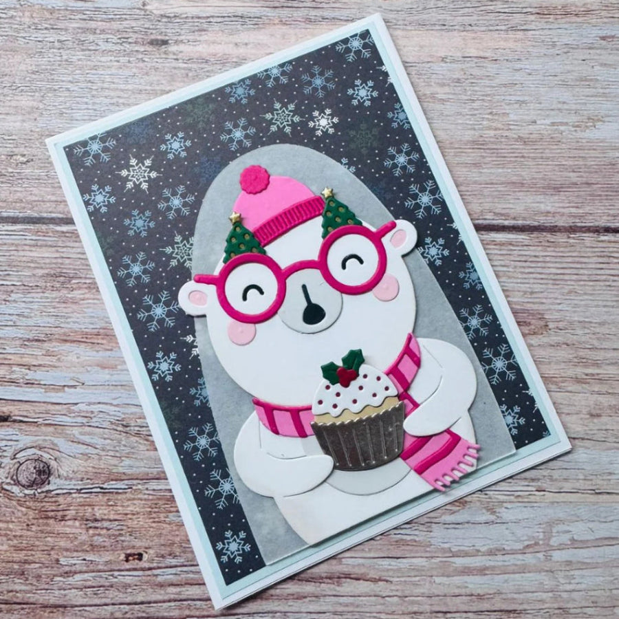 Spellbinders Spectacular Bear Etched Dies s5-722 polar bear holding cupcake pink hat and scarf snowflake background