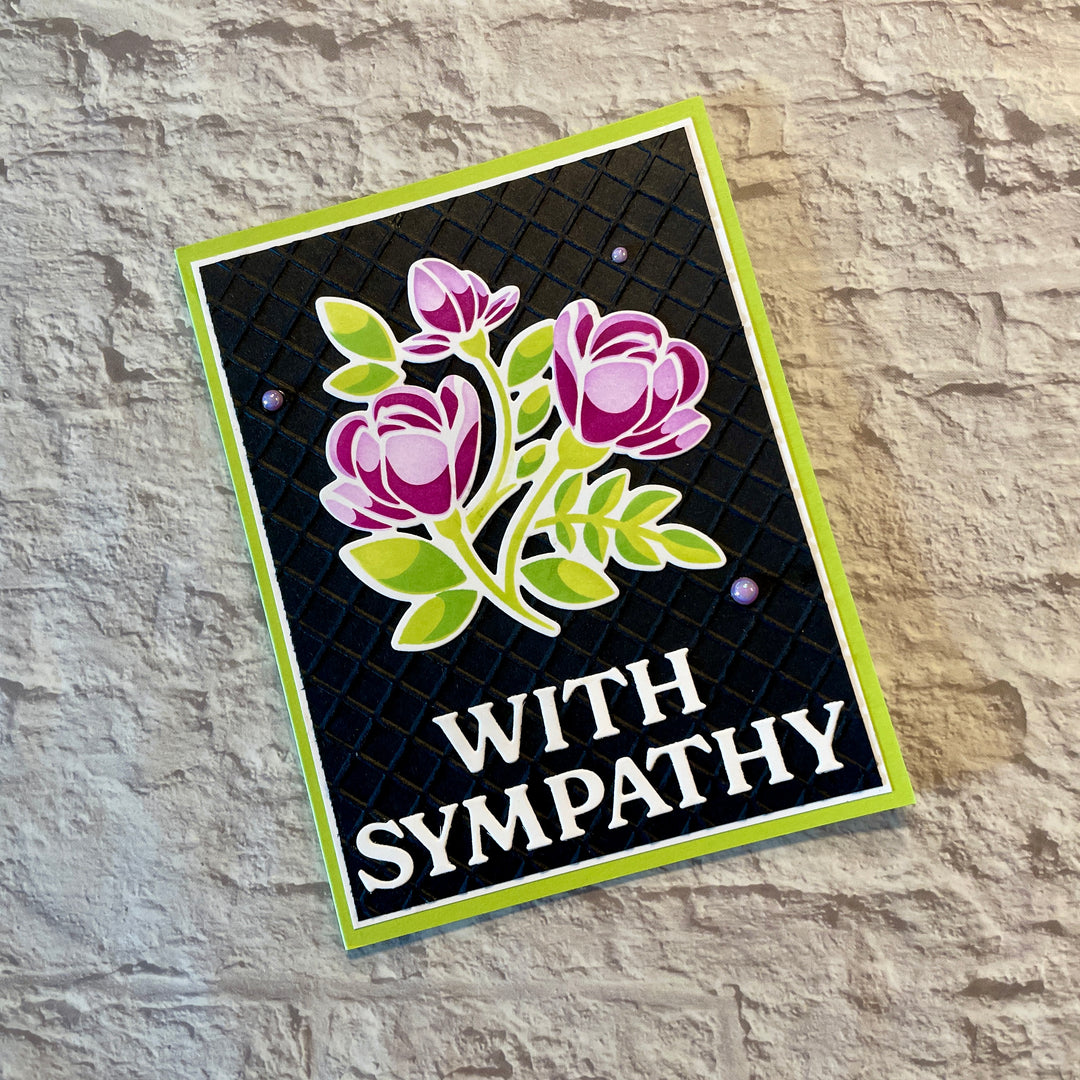 Sympathy card with floral design and 'With Sympathy' text on a stone background