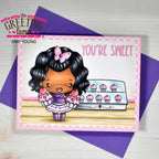 Card with a cartoon character holding cupcakes and text 'You're Sweet' on a purple envelope, branded 'The Greeting Farm' by Amy Young.