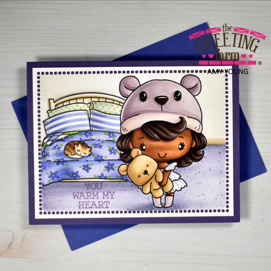 Greeting card with a cartoon character wearing a bear hat and holding a teddy bear, with 'You Warm My Heart' text, on a white background.